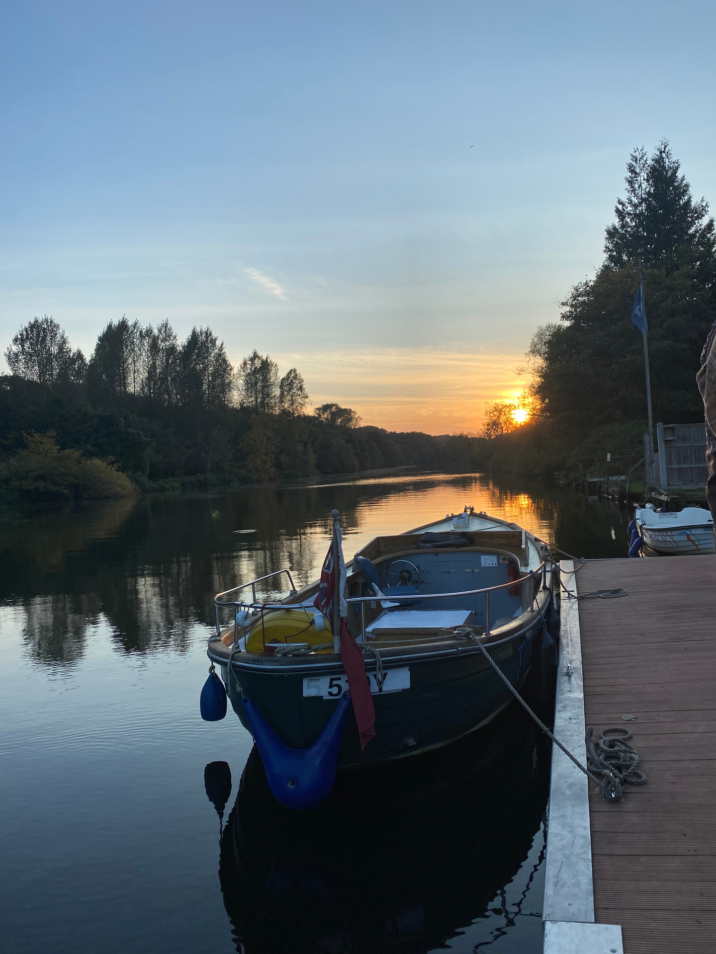 The Thorpe Ferry at the pontoon as the sun sets over the river