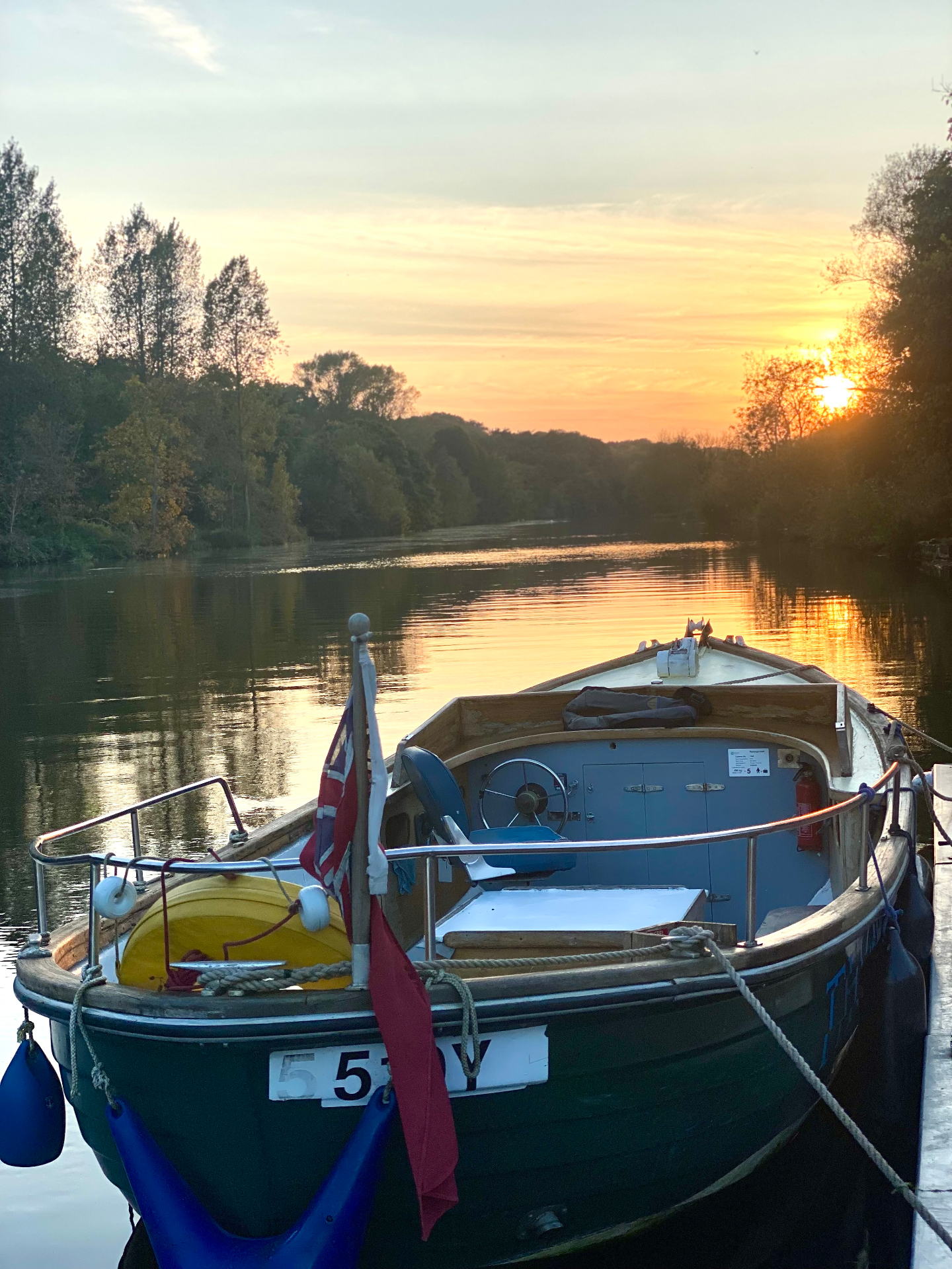 The Thorpe Ferry moored on the River Yare at golden hour