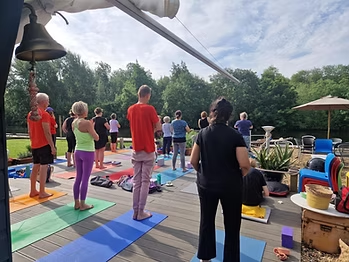 Class standing in stillness beneath the deck bell